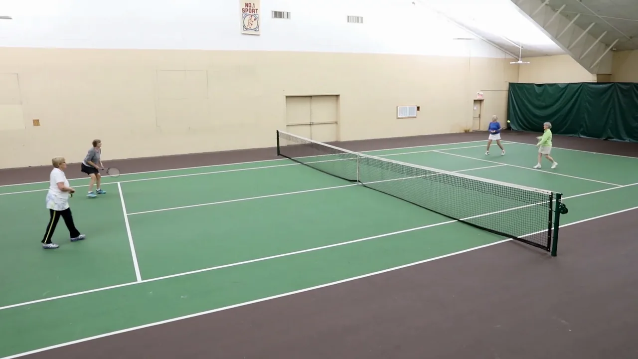Four people playing doubles on RecFit's indoor tennis court