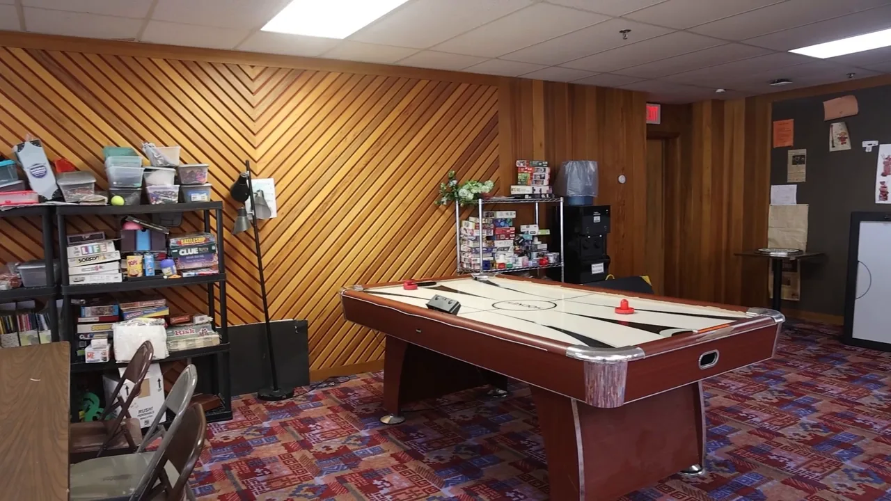 The lounge at RecFit, with an air hockey table